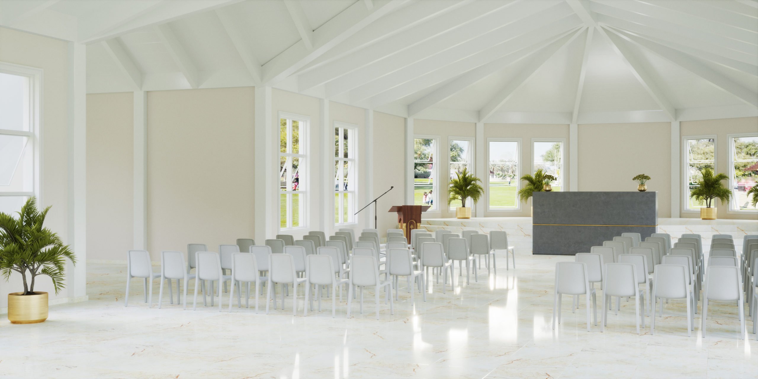 Before a room divider, several rows of white chairs in a church