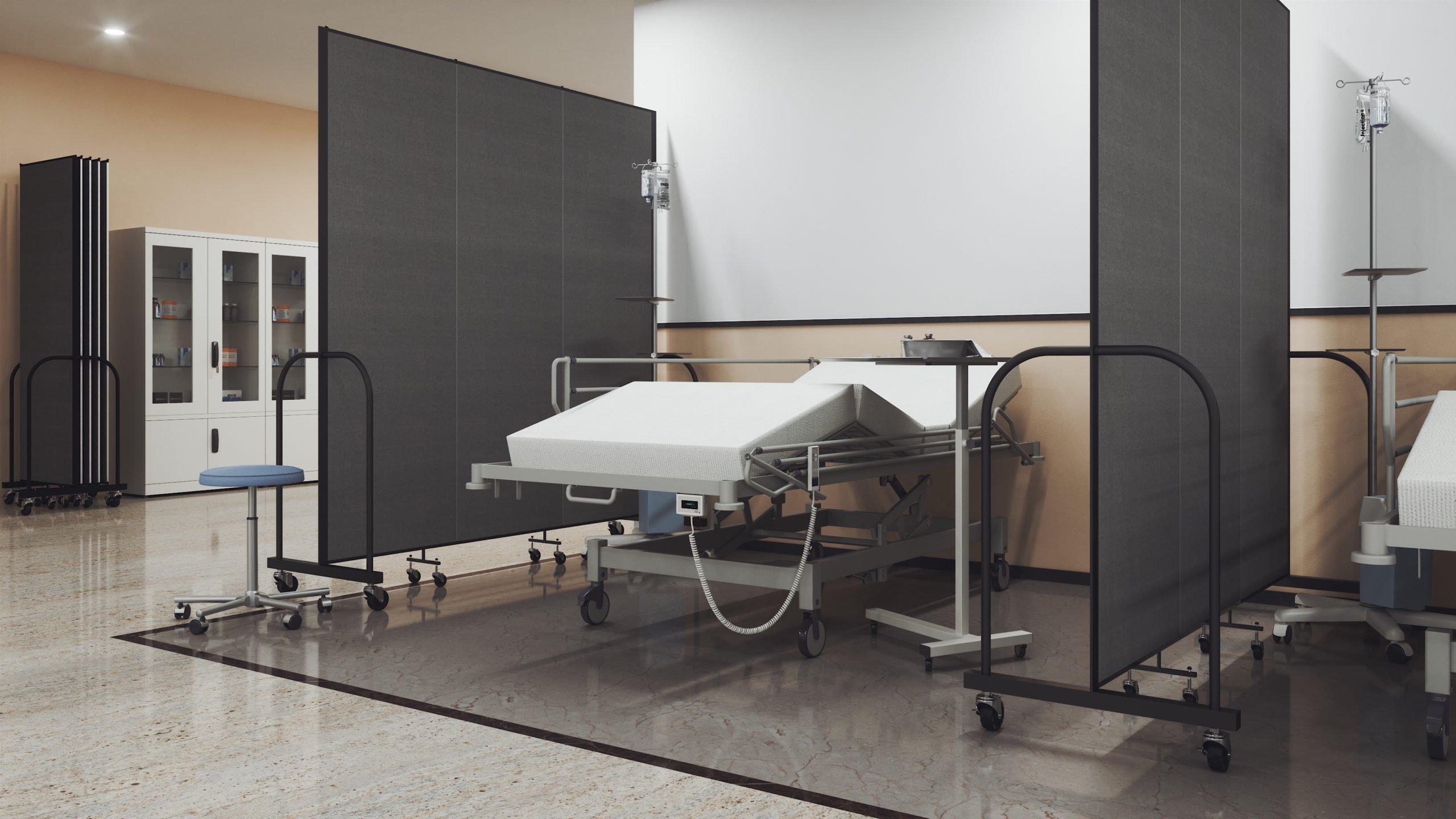 A hospital bed surrounded by room dividers on both sides