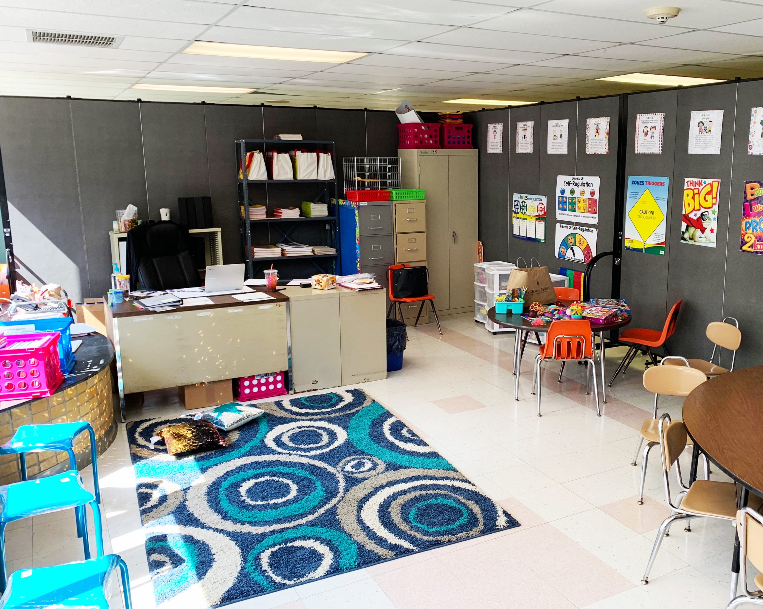 school supplies and furniture in front gray room divider