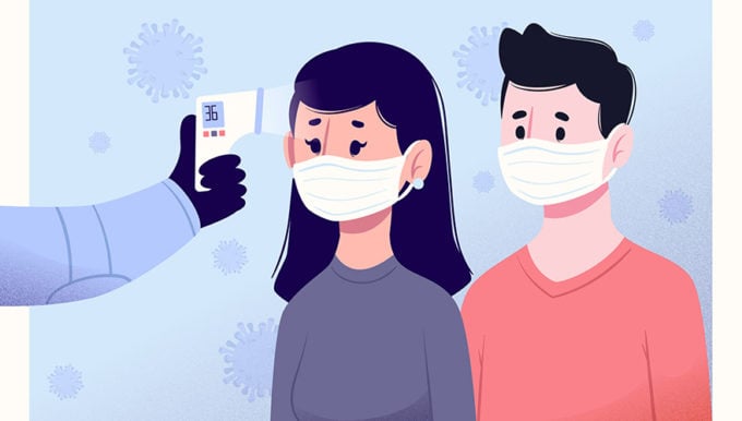 Two people getting their temperature taken and wearing masks