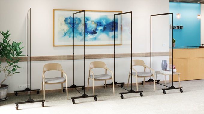 three chairs separated by clear dividers in waiting room