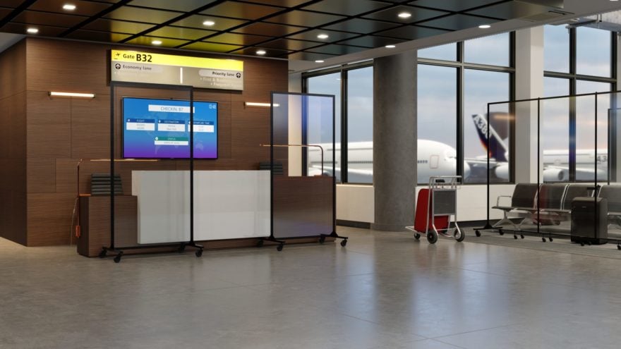 airport gate with clear barriers in front of check-in desk