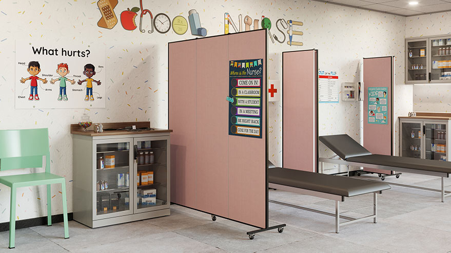 school nurse station with two empty beds and pink room dividers between them