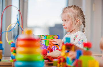 young girl playing with toys
