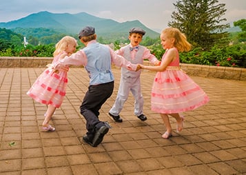 Pediatric kids dancing on an outdoor terrace