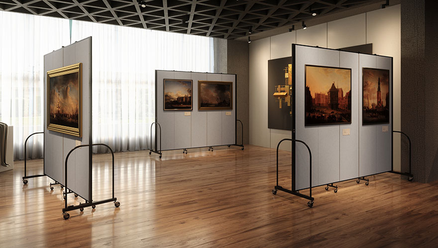 Gray freestanding art displays with framed paintings on them