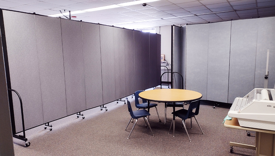 Room dividers partially surrounding table and chairs