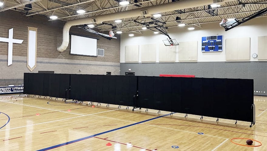 two educational spaces separated by a black room divider