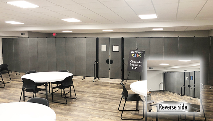 Tables and chairs in front of long gray room dividers