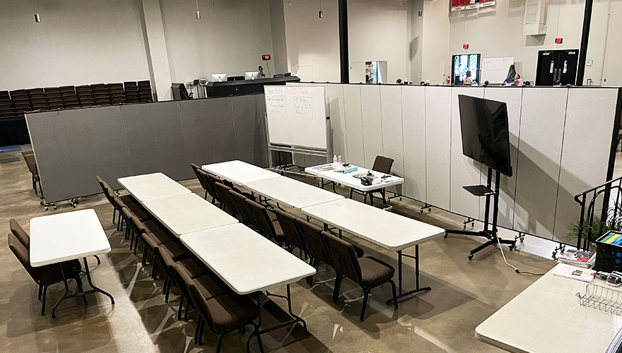 smaller classroom in a larger space framed by freestanding walls.