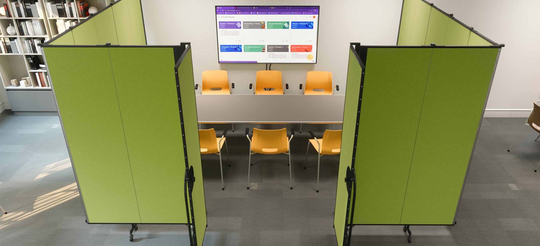 Two green room dividers partially surrounding a meeting space