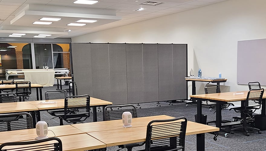 Classroom setting with a gray room divider in it