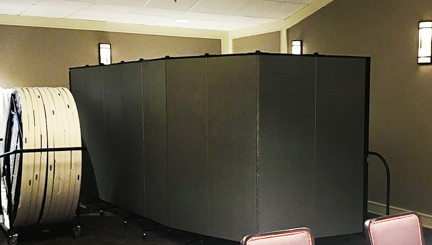 Gray room divider surrounding a a corner of a banquet space