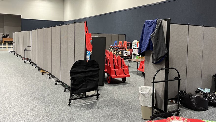 Gray room divider separating classroom space in multipurpose room