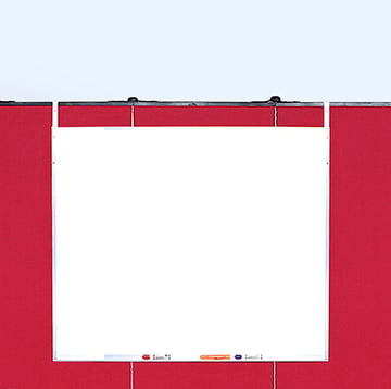 whiteboard hanging on red partition