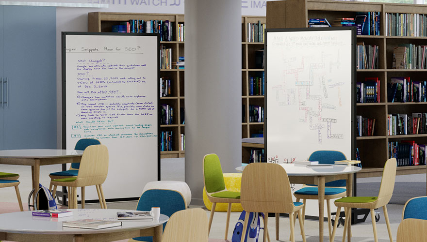 table and chairs in front of two freestanding bullet resistant whiteboards in a library