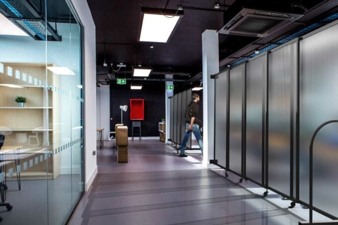 This office uses wall-,mounted polycarbonate that can transform from big hall to an alternative space